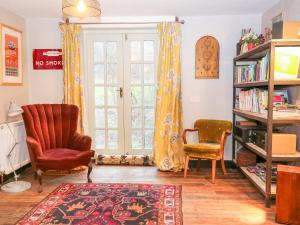 a living room with two chairs and a window at Spring Park Farmhouse in Launceston