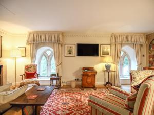 a living room with a couch and a table at All Souls Cottage in Cirencester