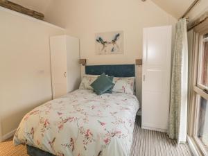 a bedroom with a bed and a window at Megs Cottage in Alveston