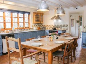 a kitchen with a wooden table and chairs at Holmwood in Montgomery