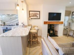 a kitchen with a bar and a living room at 8 Crown Lane in Conwy