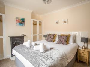 a bedroom with a large bed and a fireplace at Wey Cottage in Weymouth