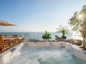 a hot tub with a view of the ocean at Cliffhanger in Hollington