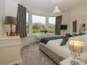 a bedroom with a bed and a large window at Cliffhanger in Hollington +67 photos