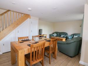 a dining room with a table and chairs and a couch at The Granary in Halstead