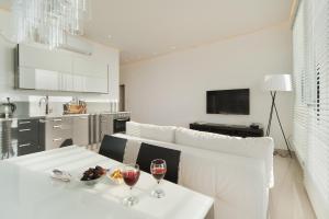 a living room with a table with two glasses of wine at Stunning Apt w/ Balcony & Sea View by Sea N' Rent in Tel Aviv