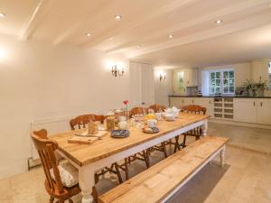 a kitchen and dining room with a table and chairs at Cardwen Farmhouse in Pelynt