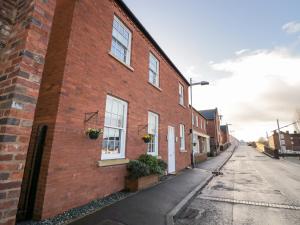 a red brick building with windows on a street at 7 Mart Lane in Stourport