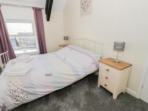a small bedroom with a bed and a window at 5 Ceirnioge Cottages in Betws-y-coed
