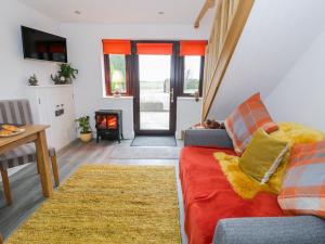 a living room with a couch and a fireplace at Bwlch Y Gwynt Bach in Llangefni