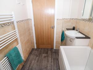 a bathroom with a sink and a toilet and a ladder at Elliott's Retreat in Sheringham +28 photos