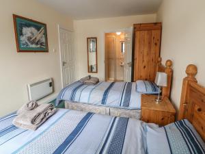 a bedroom with two beds and a tv at Apartment 42 in Bundoran