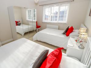 a bedroom with two beds and a table with a chair at Chinefields in Freshwater