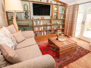 a living room with a couch and a coffee table at The Cottage The Coach House in Wrexham