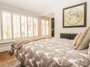 a bedroom with a large bed with a map on the wall at The Cottage The Coach House in Wrexham