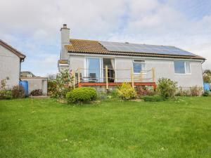 a house with solar panels on the roof at Brambles in Gorran Haven