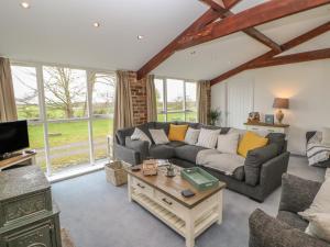 a living room with a couch and a table at The Byre in Stockton-on-Tees