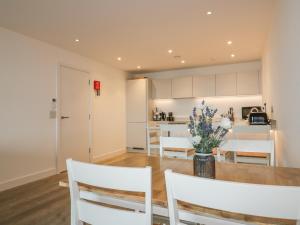 a kitchen and dining room with a table and chairs at Chapel Rock View, The Dunes in Perranporth