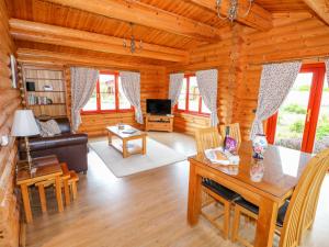 a living room with a couch and a table at Beech Lodge in Oakham