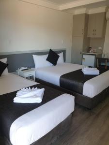 - une chambre d'hôtel avec 2 lits et des serviettes dans l'établissement Original North Australian, à Bowen