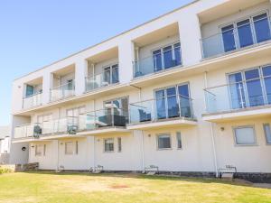 an apartment building with balconies and a yard at Ocean Seven in Newquay