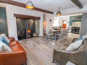 a living room with a couch and a fireplace at Llys Alaw in Abergele