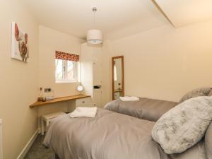 a room with two beds and a window at The Old Sty in Whiston