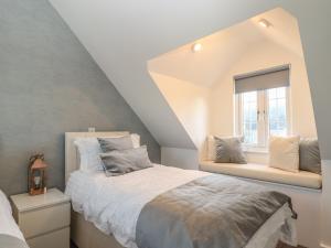 a bedroom with a bed and a window at Kober House in Helston