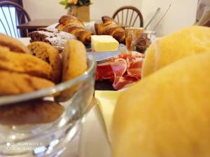 a table with a plate of pastries and other foods at Mini hotel in Quincinetto