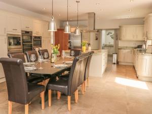 a kitchen with a dining room table and chairs at Lower Norton Farmhouse in Dartmouth