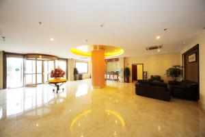 a large living room with a large yellow ceiling at Greentree Inn Shanghai West Huaxia Road Metro Station Express Hotel in Shanghai