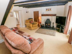 a living room with a couch and a fireplace at Cheriton Villa in Tenby