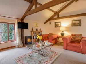 a living room with red furniture and a fireplace at Churn House in Dorchester