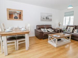 a living room with a couch and a table at Bayside Cottage in Filey +4 photos