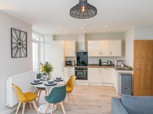 a kitchen and dining room with a table and chairs at SeaSound in Ilfracombe