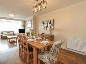 uma sala de jantar e sala de estar com mesa e cadeiras em Beach Cove View em Newbiggin-by-the-Sea