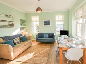 a living room with a couch and a table at Hartland View in Woolacombe