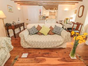 a living room with a couch with pillows on it at The Coach House in Berwick-Upon-Tweed