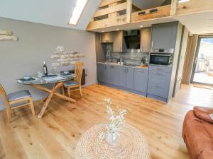 a kitchen and living room with a table and a couch at Thompson Rigg Barn in Scarborough