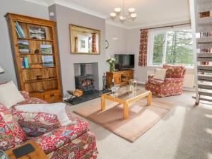 a living room with two couches and a fireplace at Kirkstone Cottage in Ambleside
