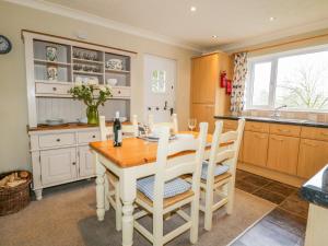 a kitchen with a table and chairs in a kitchen at Kirkstone Cottage in Ambleside