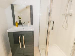 a bathroom with a sink and a shower at Kirkstone Cottage in Ambleside +14 photos