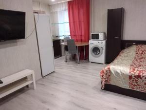 a hotel room with a bed and a washing machine at Chap34 in Borisov in Borisov