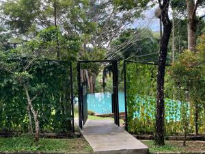 a gate leading to a pool in a garden at 2 bed Kempas D2-705 Genting Highland in Genting Highlands