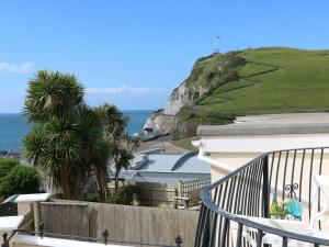 a balcony of a house with a view of the ocean at 10 Cove View in Ilfracombe