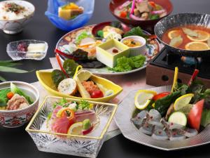 a table with plates of food and bowls of food at Nisshokan Shinkan Baishokaku in Nagasaki