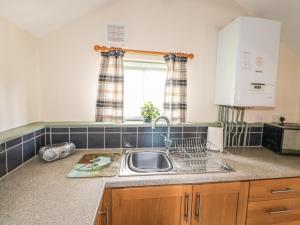 a kitchen counter with a sink and a window at The Bull Pen in Eye