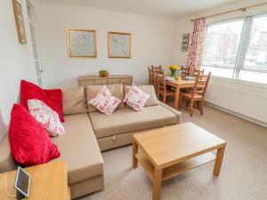 a living room with a couch and a table at The Wynd Apartment in Morpeth