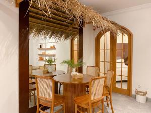 a dining room with a wooden table and chairs at youre at - The Majesty Apartment in Bandung