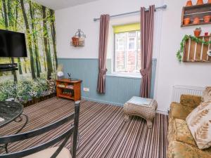 a living room with a couch and a window at River Cottage in Port Talbot